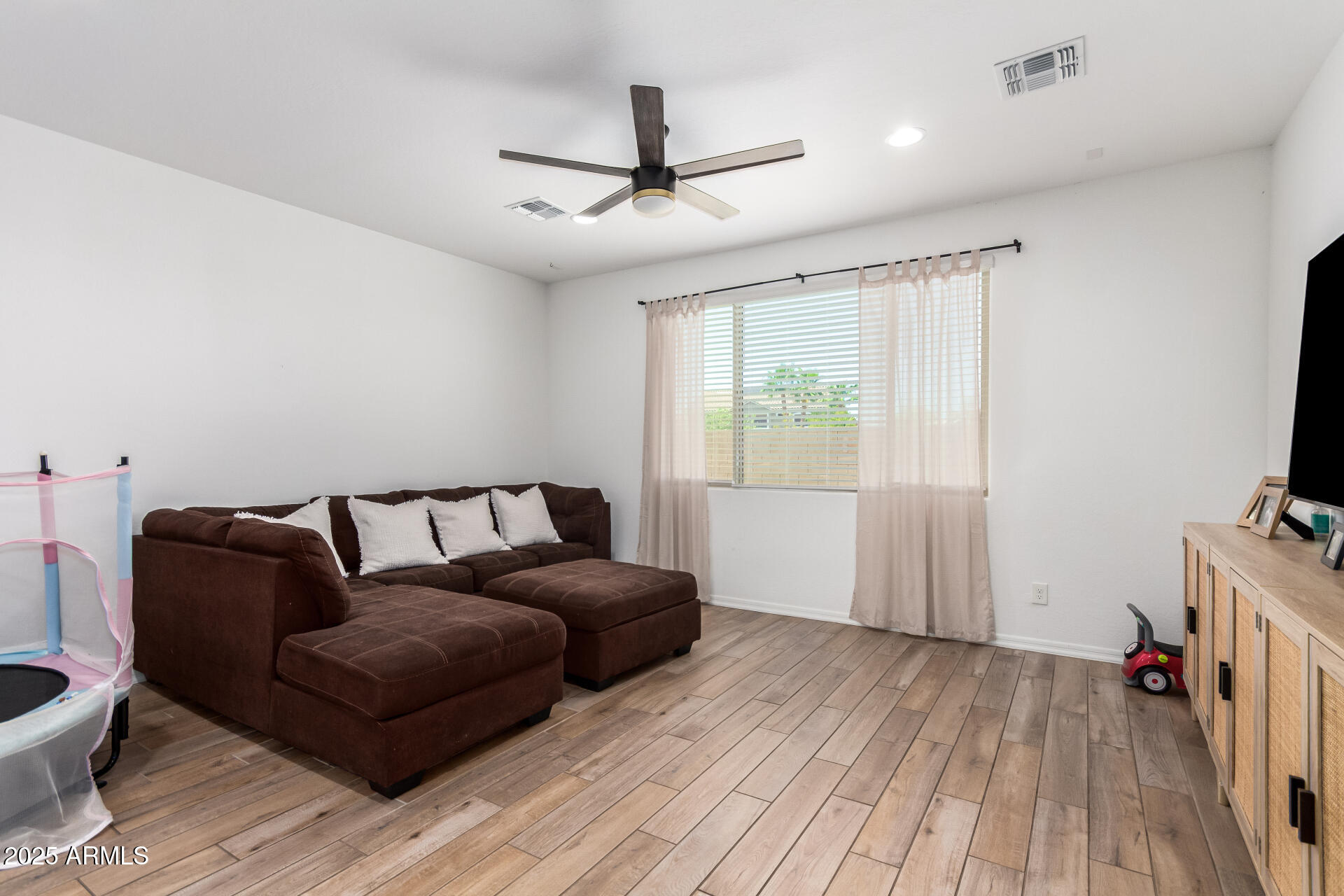 24608 Seed Road Florence, AZ 85132 - Photo 9 of 45 a living room with furniture and a wooden floor