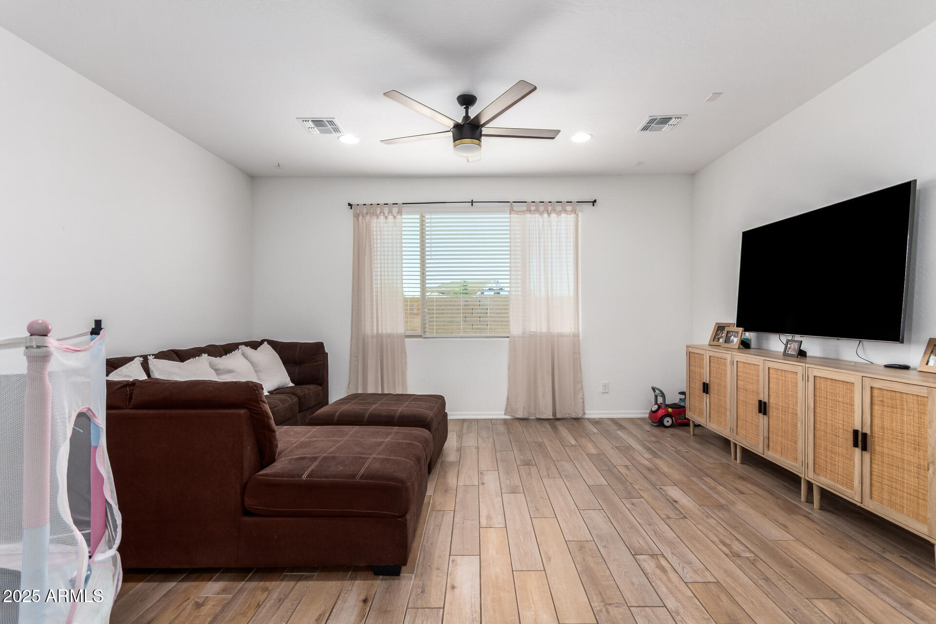 24608 Seed Road Florence, AZ 85132 - Photo 10 of 45 a living room with furniture and a flat screen tv