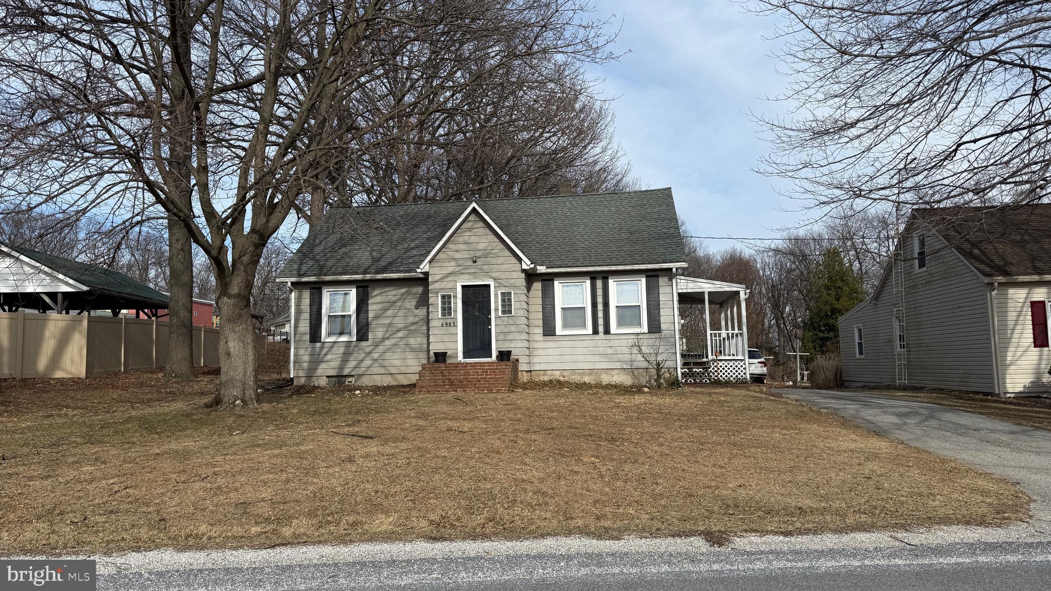 6983 Lake Road York, PA 17403 - Photo 1 of 28 a front view of a house with a yard covered with snow and trees