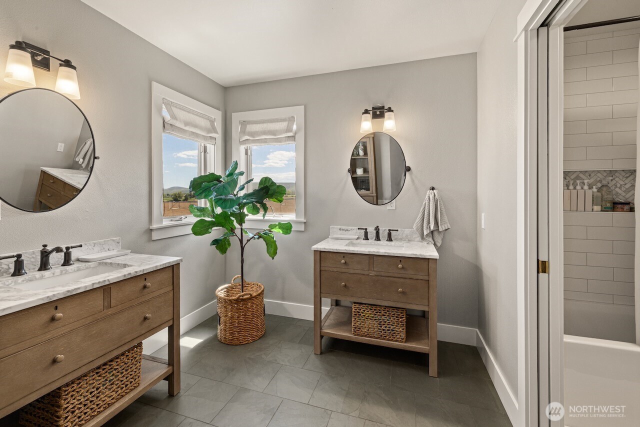 3920 Weaver Road Ellensburg, WA 98926 - Photo 27 of 40 a bathroom with a double vanity sink and a mirror