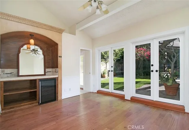 a view of a livingroom with a fireplace wooden floor and front door