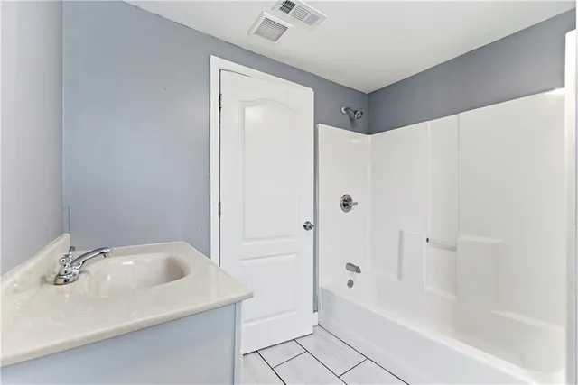 a bathroom with a bathtub and shower