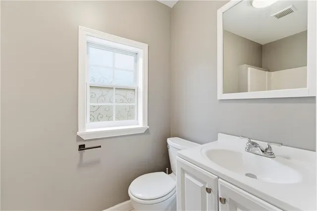 a bathroom with a sink toilet and mirror