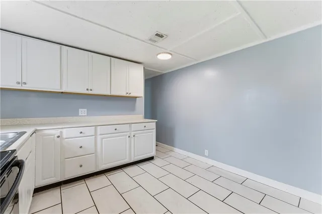 a kitchen with white cabinets