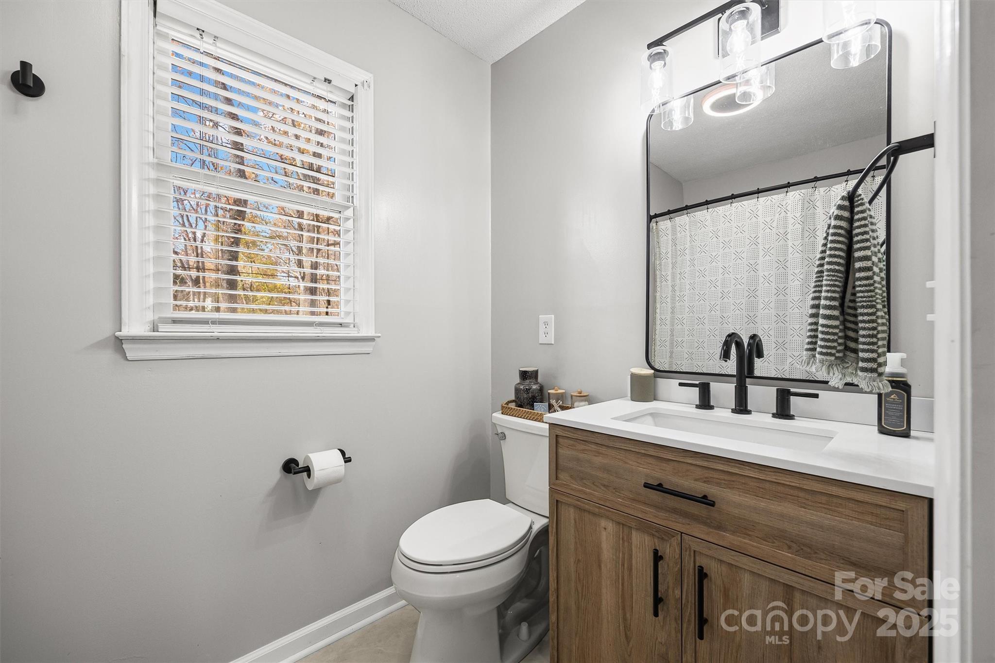 521 Rabun Circle Rock Hill, SC 29730 - Photo 15 of 28 a bathroom with a granite countertop toilet sink and mirror