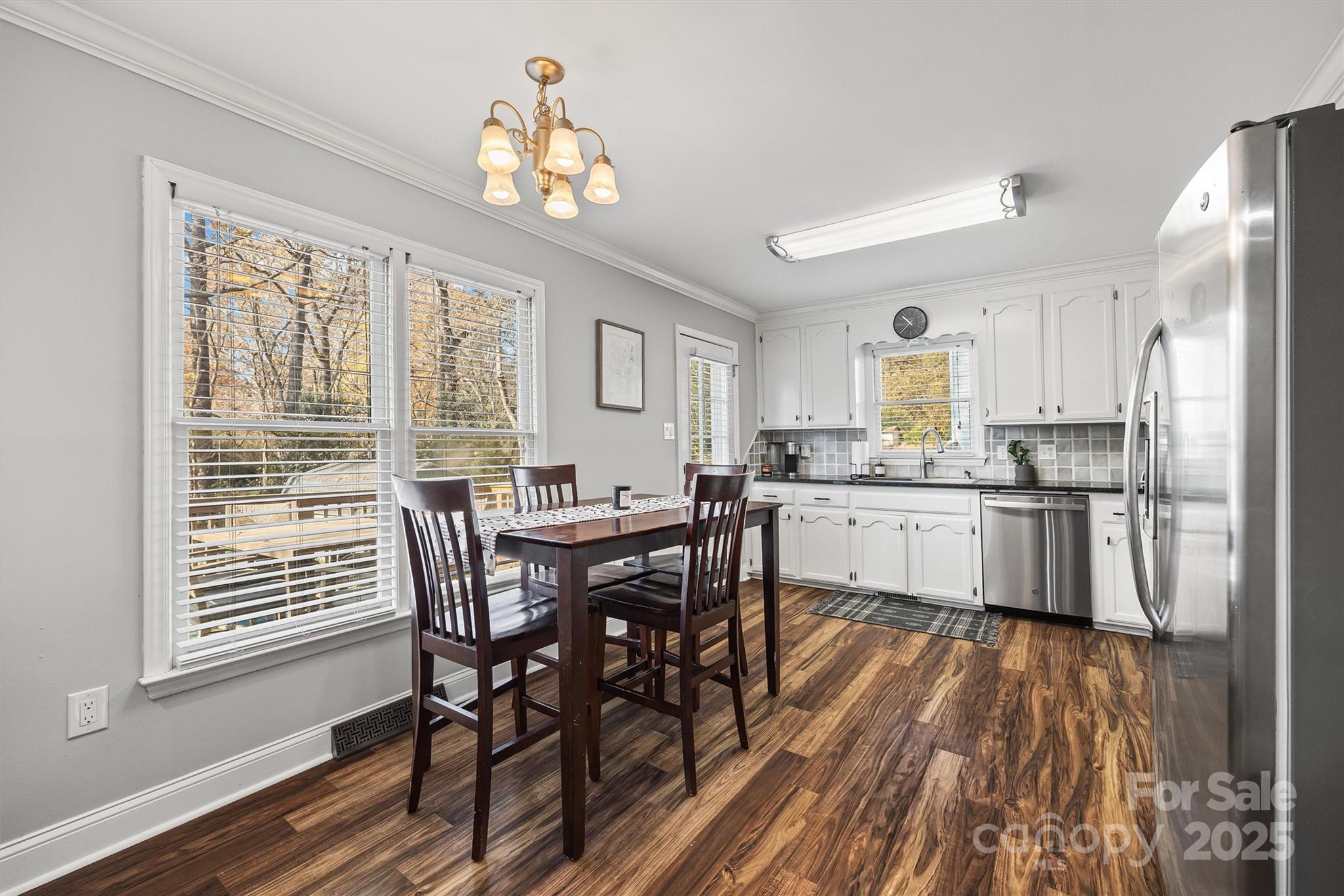 521 Rabun Circle Rock Hill, SC 29730 - Photo 8 of 28 a kitchen with stainless steel appliances granite countertop a kitchen island hardwood floor and a view of living room