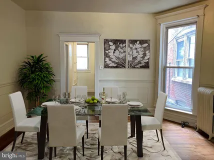 a dining room with furniture and window