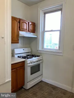 a stove top oven sitting inside of a kitchen