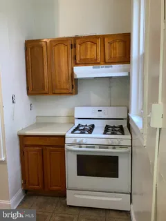 a kitchen with a stove and a cabinet