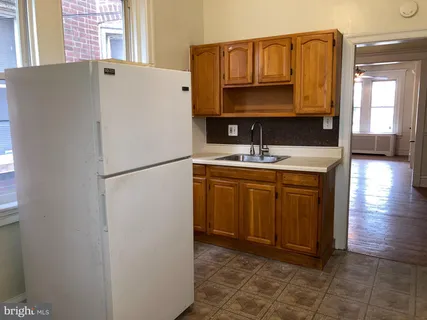 a kitchen with a refrigerator and a sink