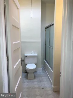 a bathroom with a toilet and a shower