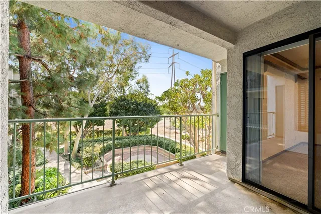 a view of balcony with a couple of cars parked in road