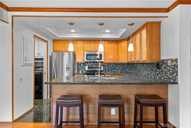 a kitchen with a sink and a refrigerator