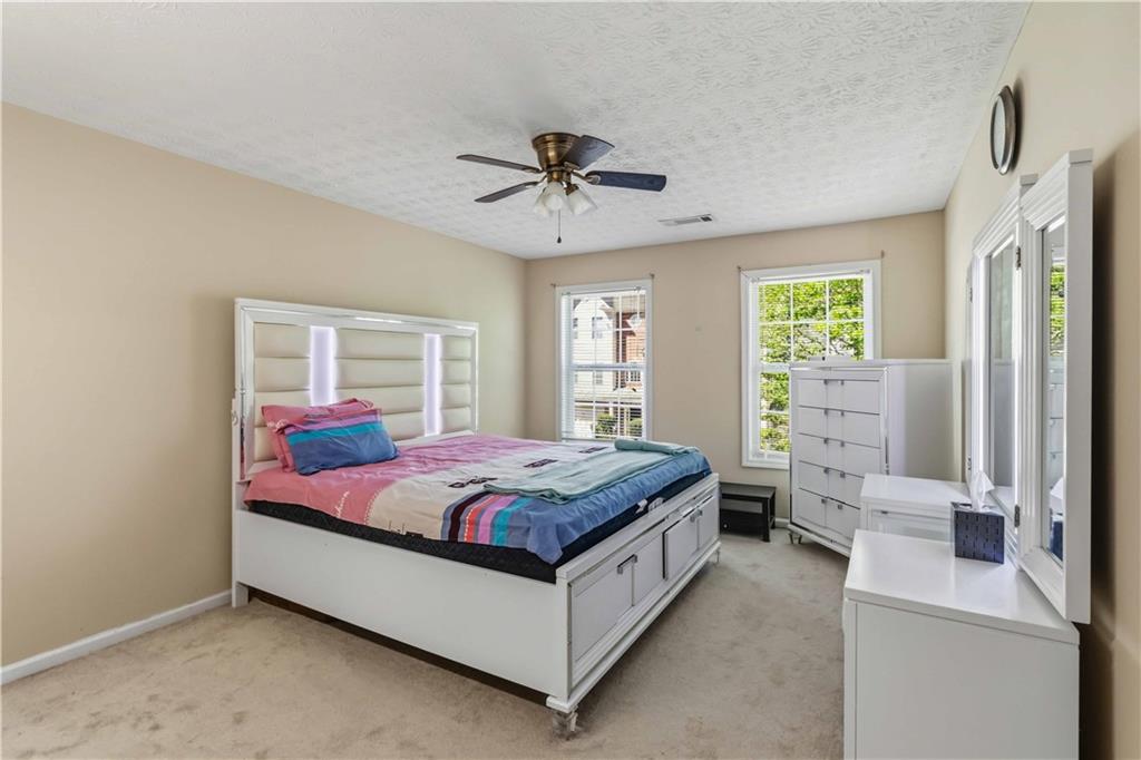 6031 Grovegate Lane Tucker, GA 30084 - Photo 12 of 26 a bed room with a bed and window