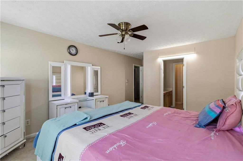 6031 Grovegate Lane Tucker, GA 30084 - Photo 13 of 26 a bedroom with a bed and window