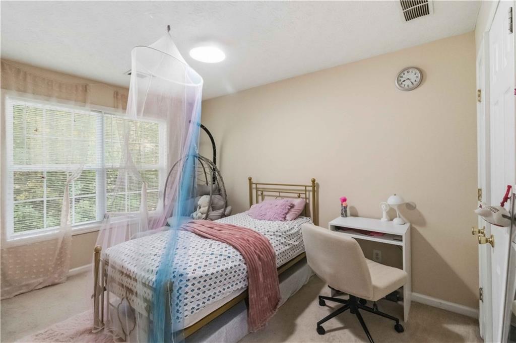 6031 Grovegate Lane Tucker, GA 30084 - Photo 17 of 26 a bedroom with a bed and a window