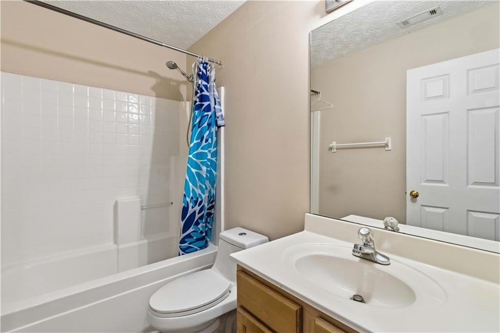 6031 Grovegate Lane Tucker, GA 30084 - Photo 20 of 26 a bathroom with a sink toilet and shower