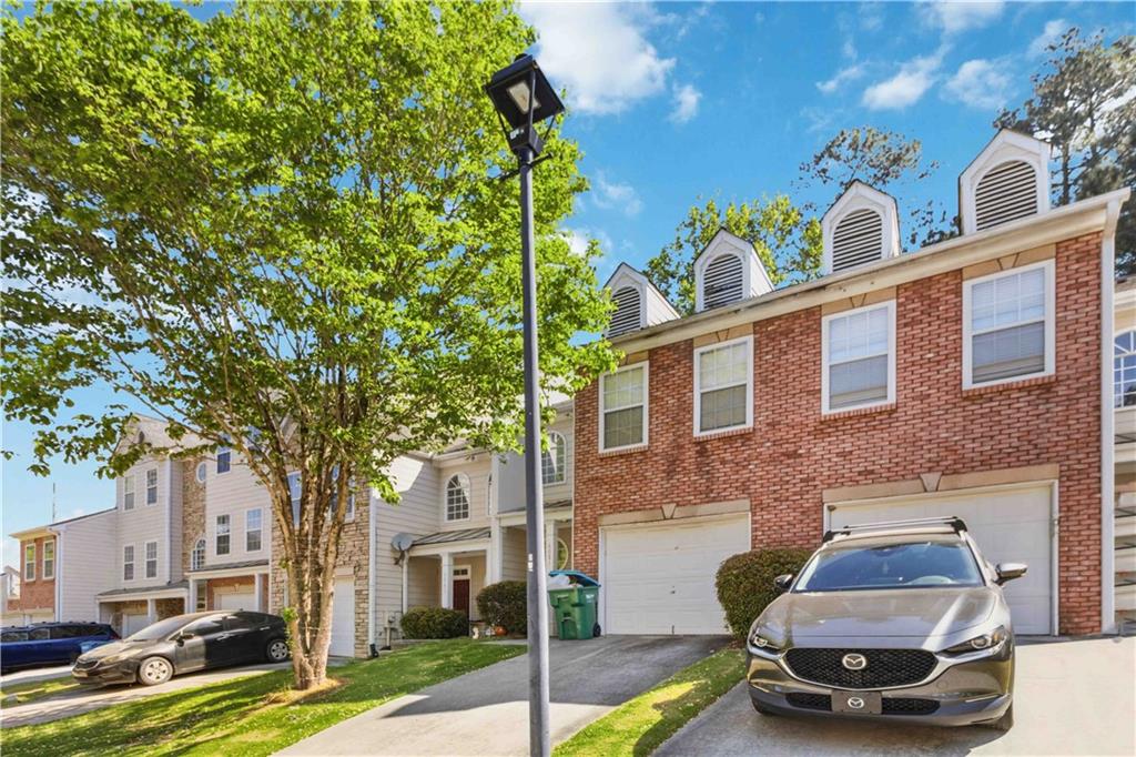6031 Grovegate Lane Tucker, GA 30084 - Photo 2 of 26 a car parked in front of a brick house