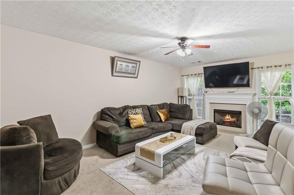 6031 Grovegate Lane Tucker, GA 30084 - Photo 5 of 26 a living room with furniture a flat screen tv and a fireplace