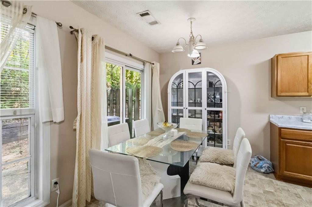 6031 Grovegate Lane Tucker, GA 30084 - Photo 8 of 26 a view of a dining room with furniture window and outside view