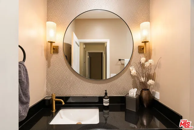 a room with a mirror and furniture