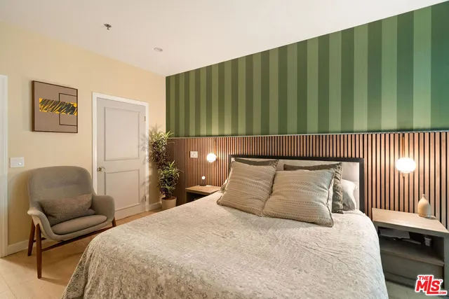 a bedroom with a bed and chair