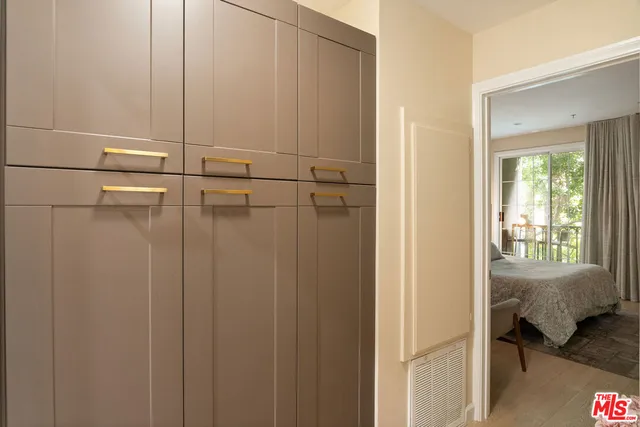 a view of a bedroom with a bed and a window