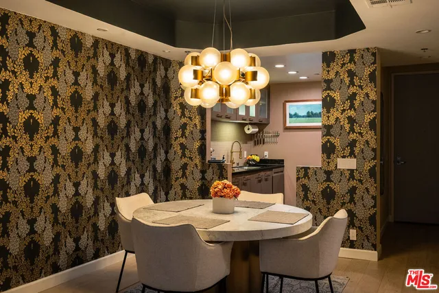 a view of a dining room with furniture and chandelier