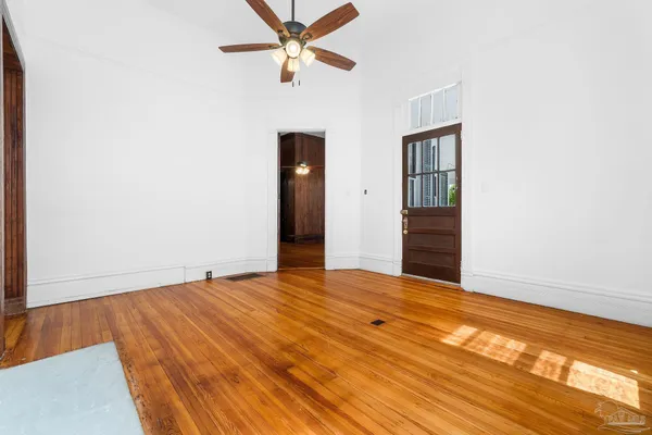a living room with couches and painted walls with wooden floor