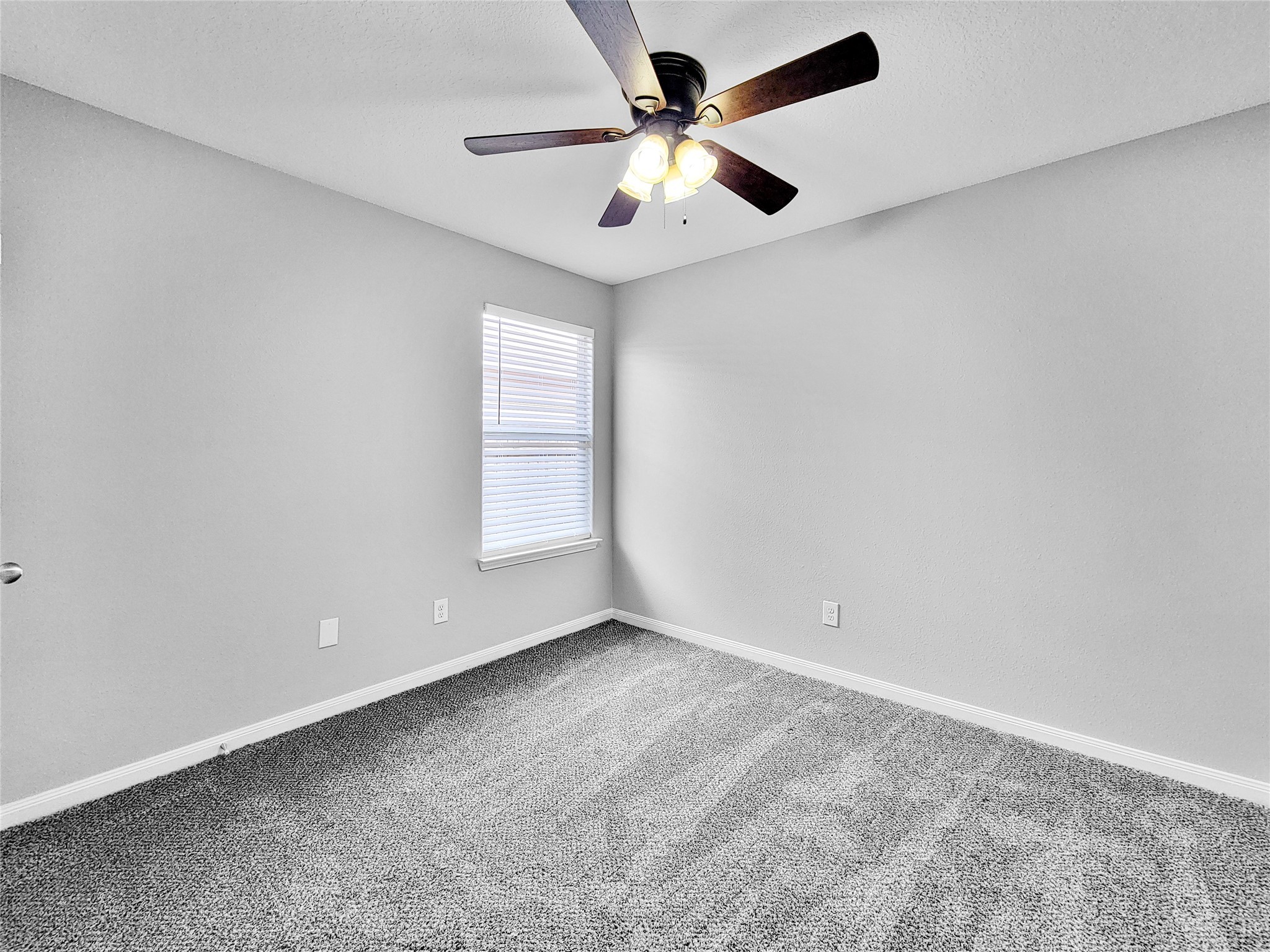 930 Paradise Road Baytown, TX 77521 - Photo 12 of 18 an empty room with windows and fan