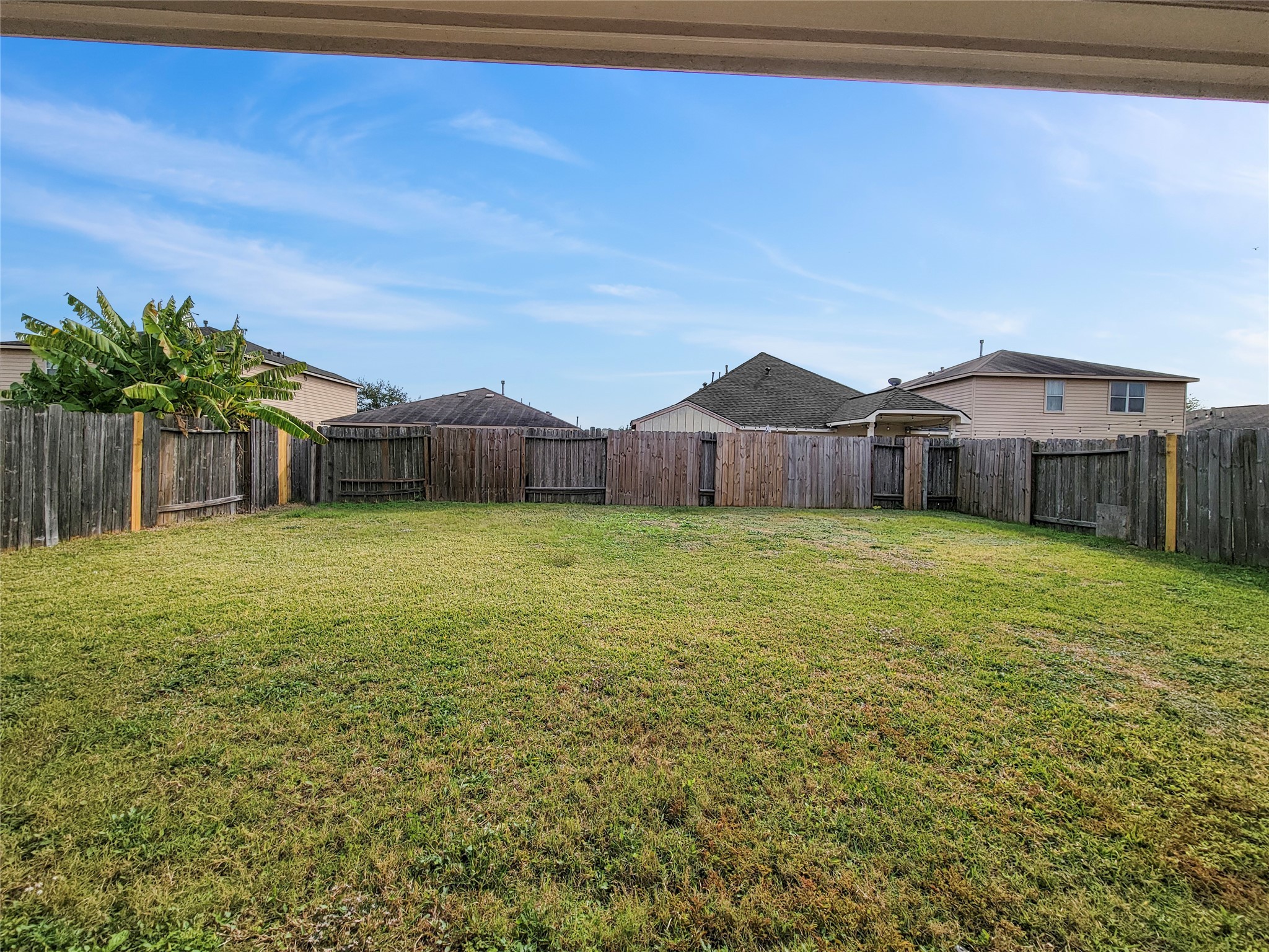 930 Paradise Road Baytown, TX 77521 - Photo 16 of 18 a front view of a house with a garden and yard