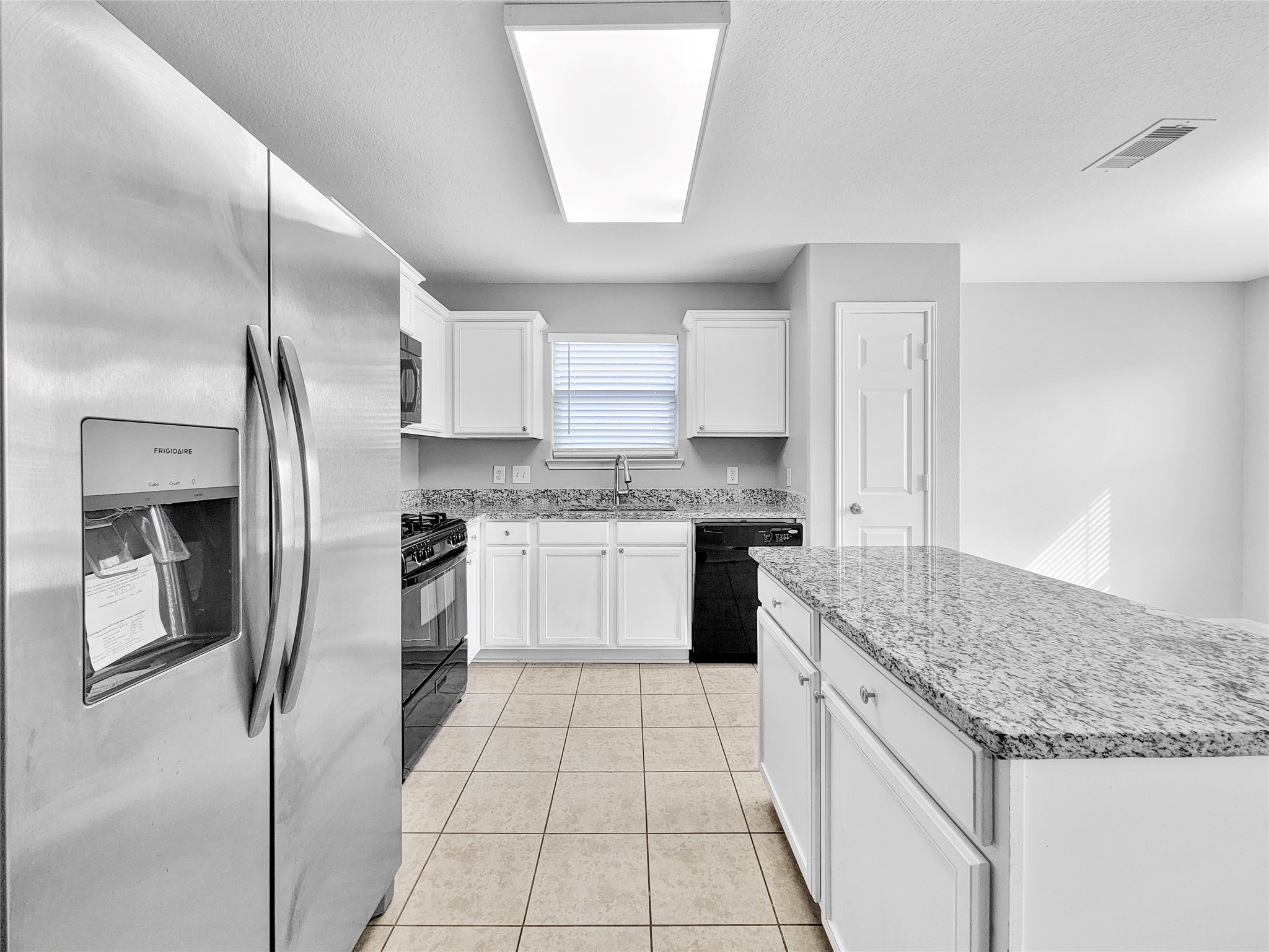 930 Paradise Road Baytown, TX 77521 - Photo 6 of 18 a kitchen with stainless steel appliances granite countertop a refrigerator sink and cabinets