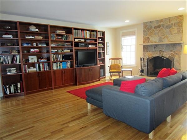52 Manor Avenue Wellesley, MA 02482 - Photo 6 of 6 a living room with furniture a flat screen tv and bookshelf