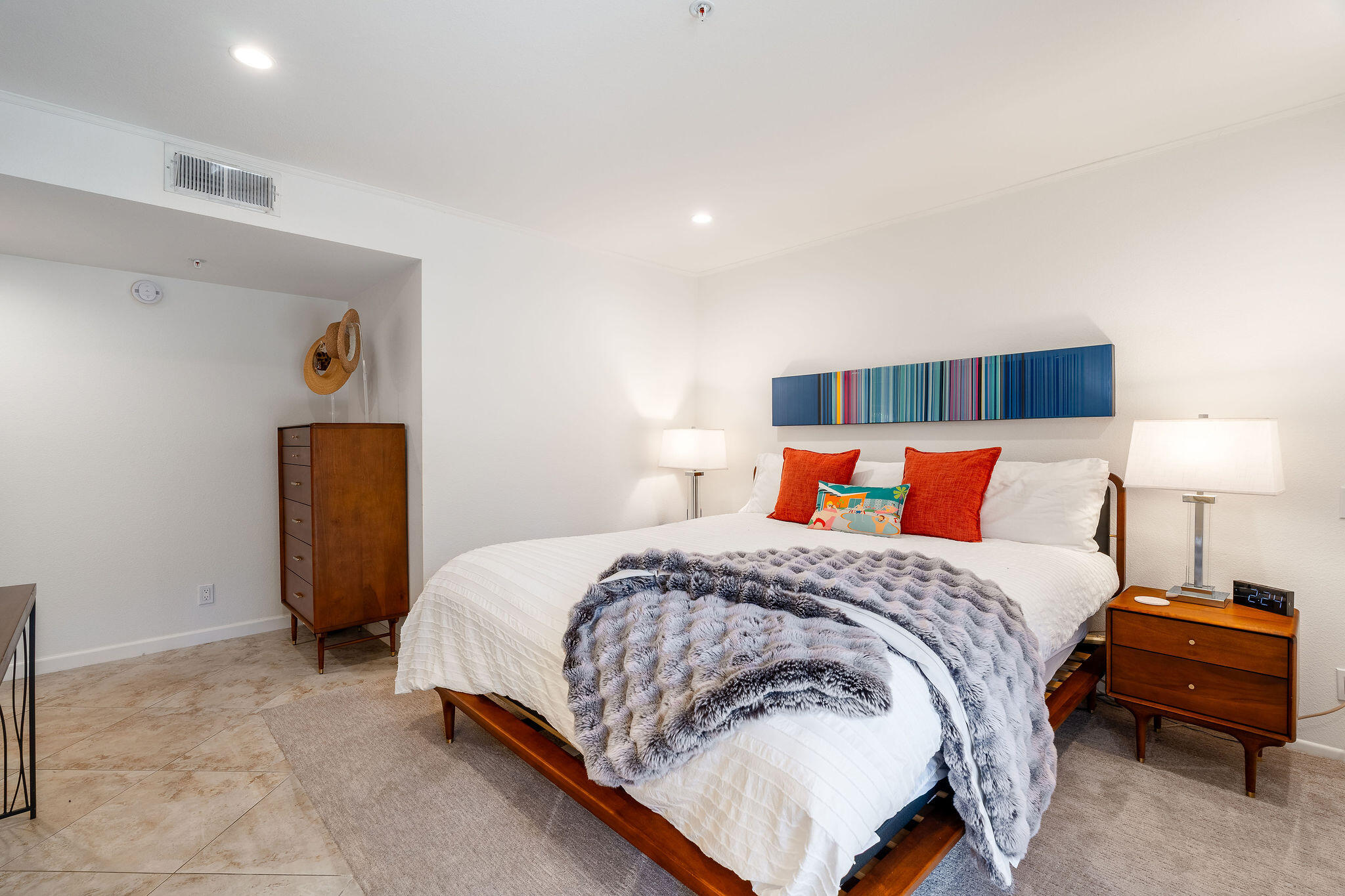 500 East Amado Road, Unit 106 Palm Springs, CA 92262 - Photo 12 of 30 a bedroom with a bed and a lamp