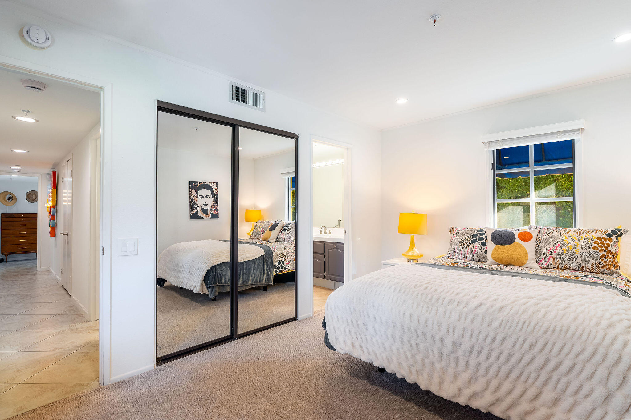 500 East Amado Road, Unit 106 Palm Springs, CA 92262 - Photo 17 of 30 a bed room with a bed and a painting