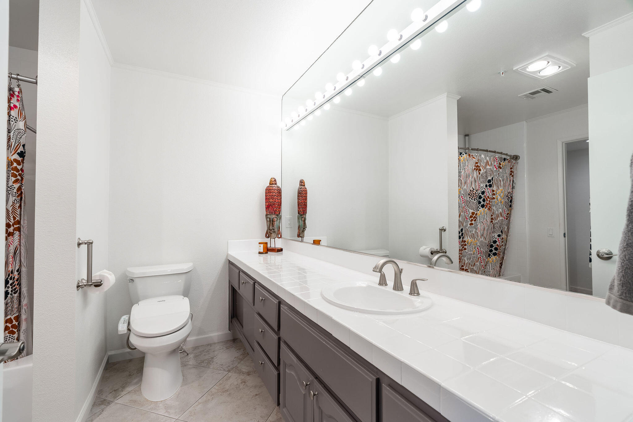 500 East Amado Road, Unit 106 Palm Springs, CA 92262 - Photo 18 of 30 a bathroom with a granite countertop sink a toilet and a mirror