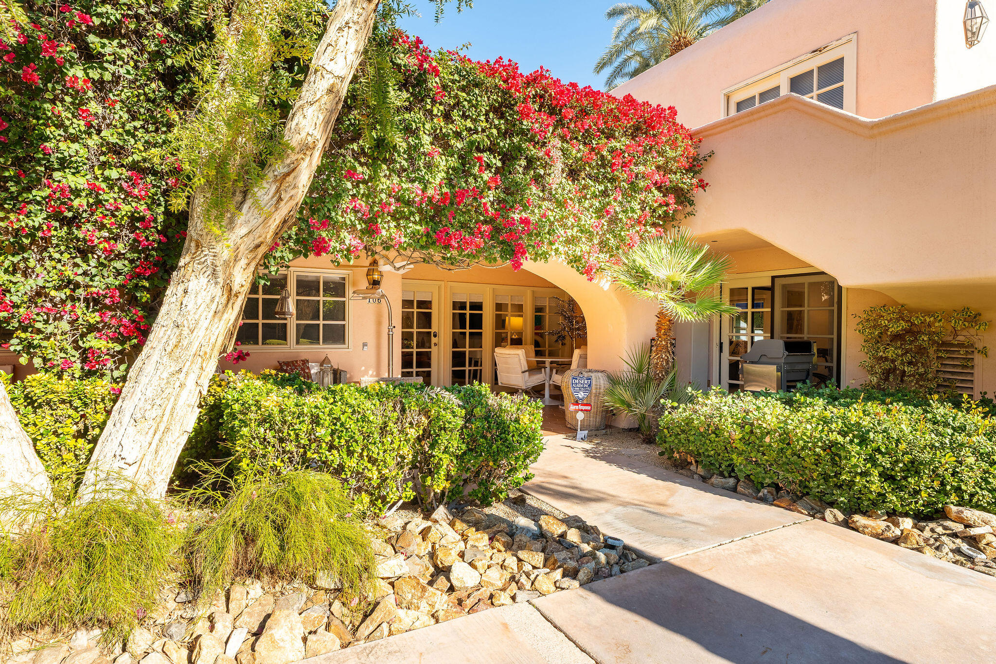 500 East Amado Road, Unit 106 Palm Springs, CA 92262 - Photo 19 of 30 a front view of a multi story residential apartment building with yard and parking