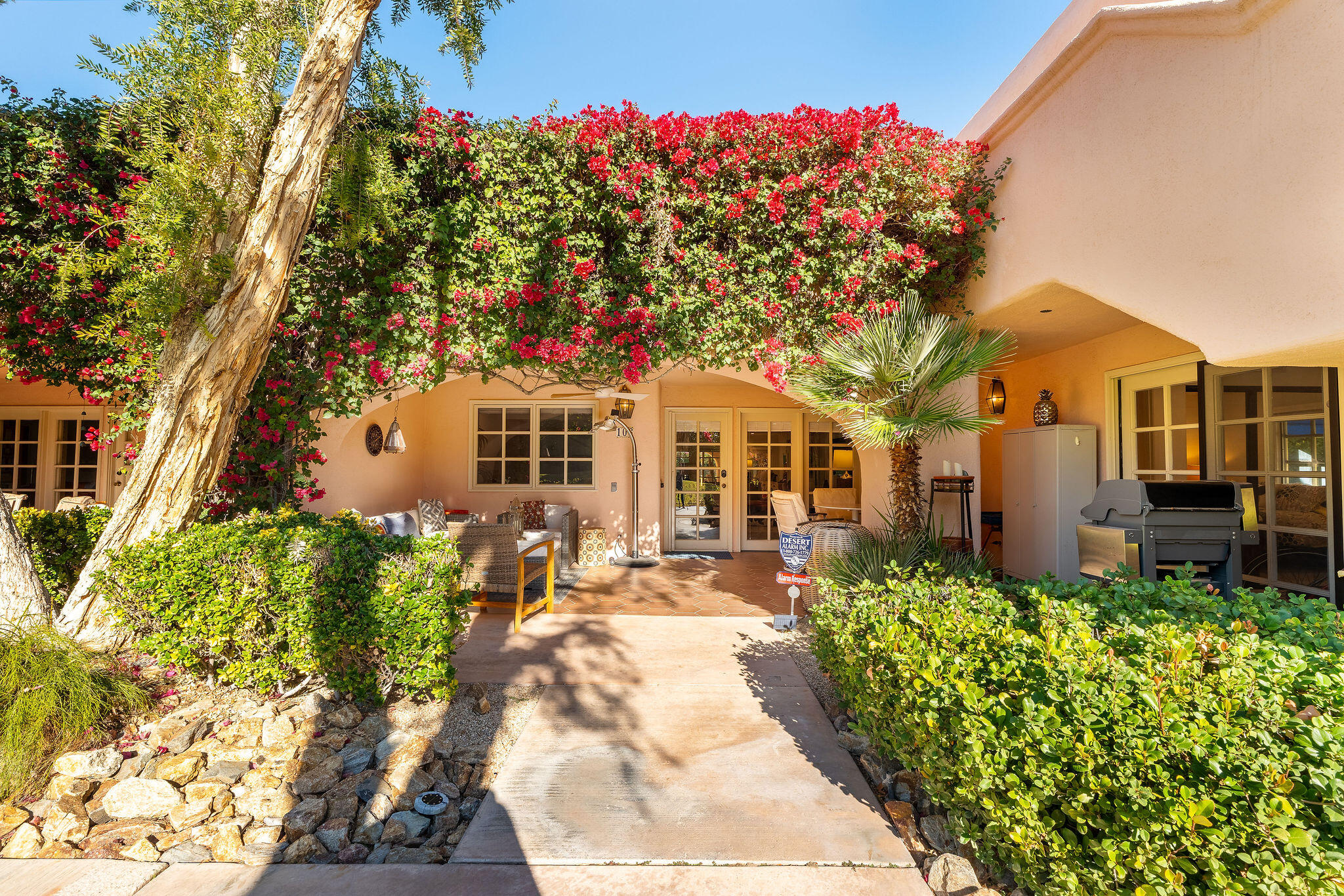 500 East Amado Road, Unit 106 Palm Springs, CA 92262 - Photo 20 of 30 a front view of a house with a yard