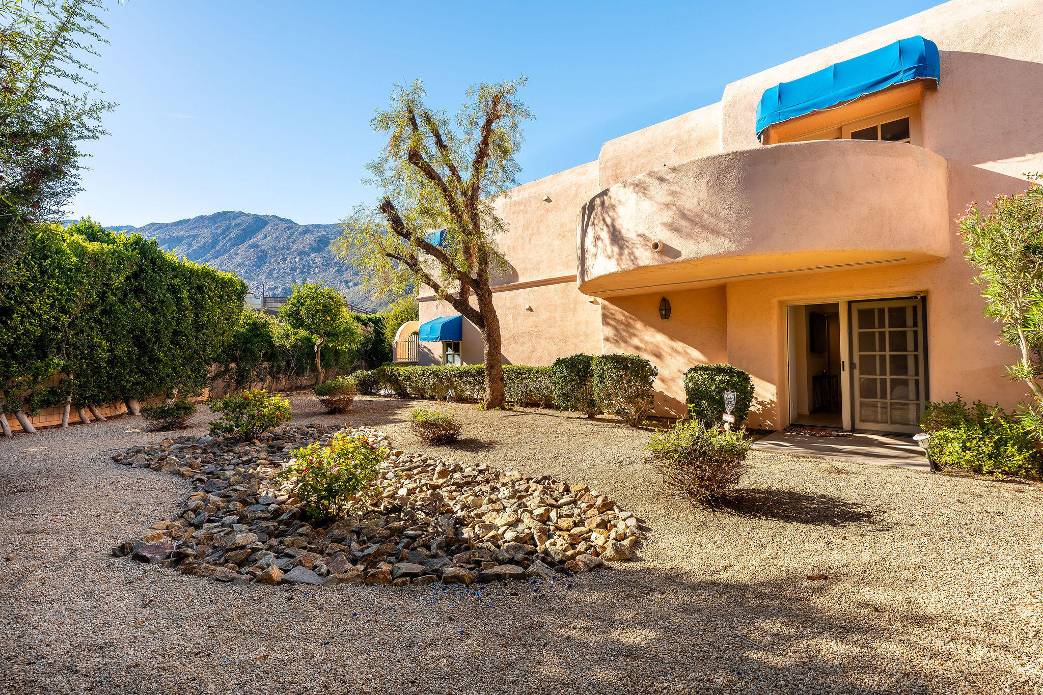 500 East Amado Road, Unit 106 Palm Springs, CA 92262 - Photo 23 of 30 a view of a house with a yard and sitting area