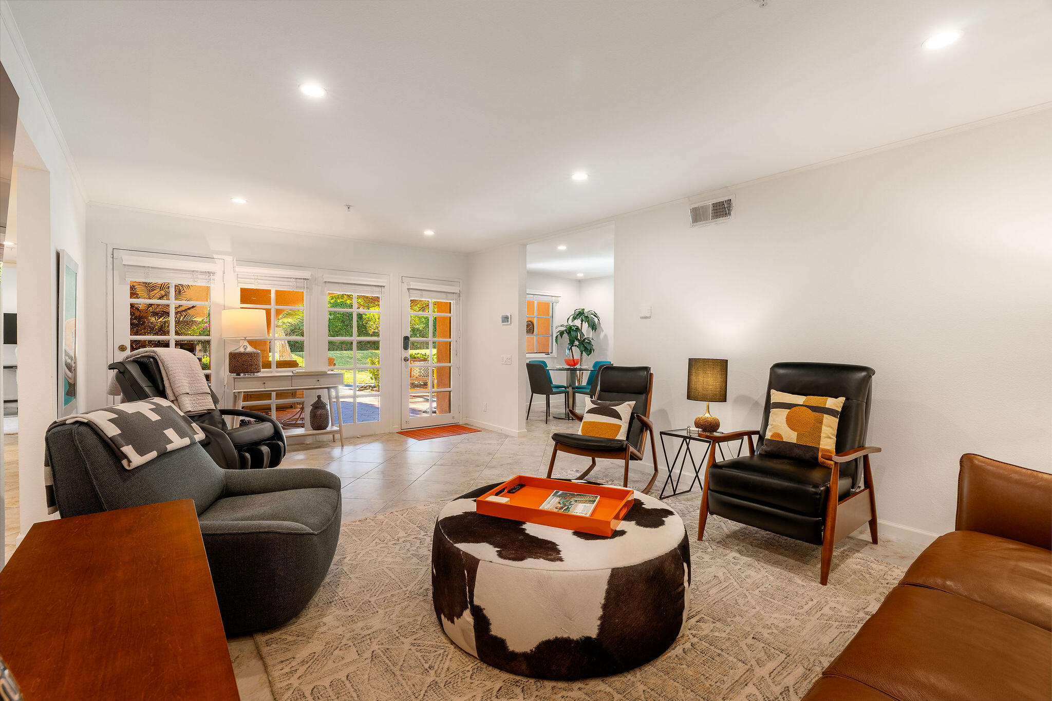 500 East Amado Road, Unit 106 Palm Springs, CA 92262 - Photo 3 of 30 a living room with furniture and a flat screen tv