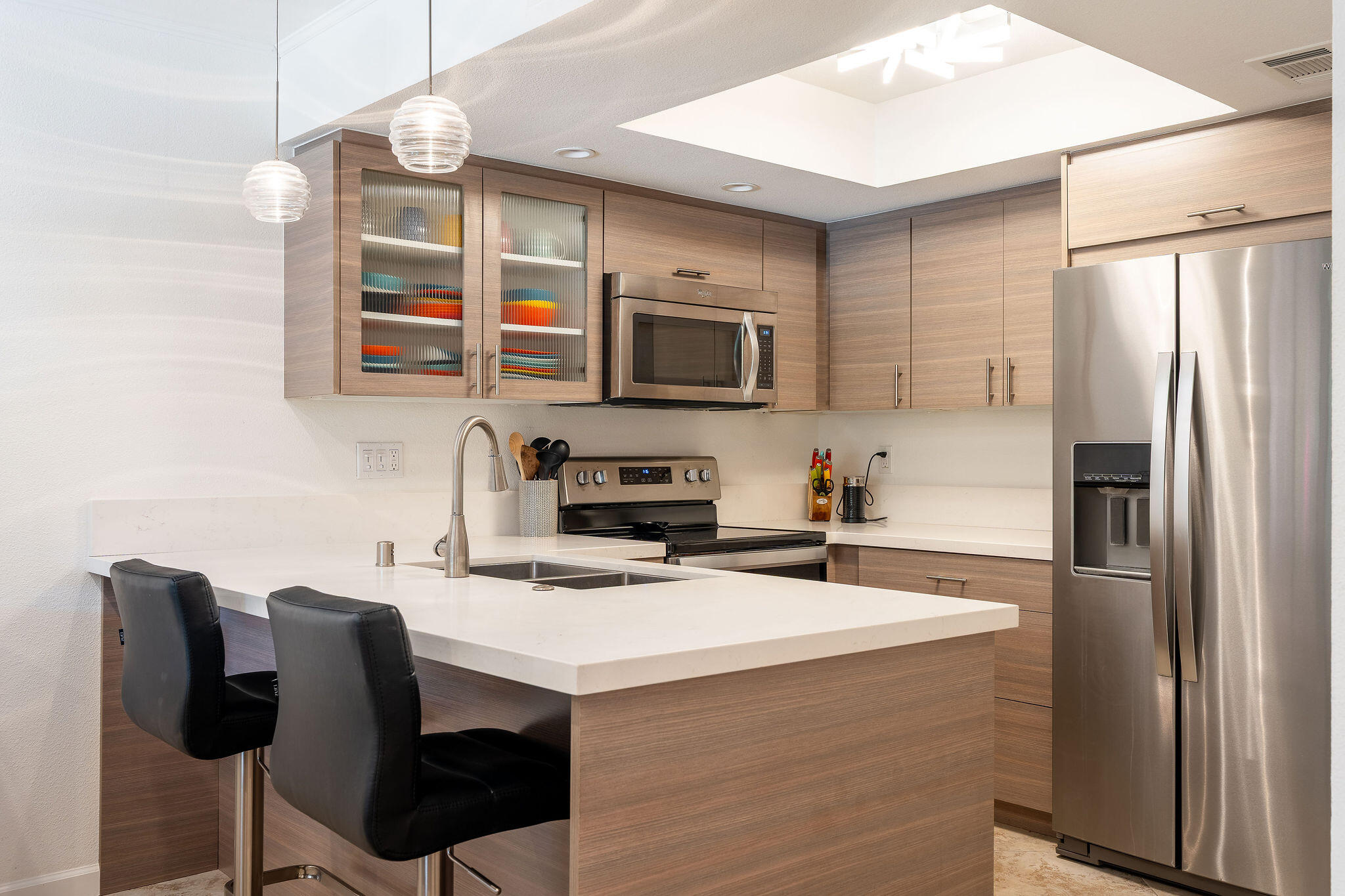 500 East Amado Road, Unit 106 Palm Springs, CA 92262 - Photo 6 of 30 a kitchen with stainless steel appliances a stove a sink refrigerator and a chair