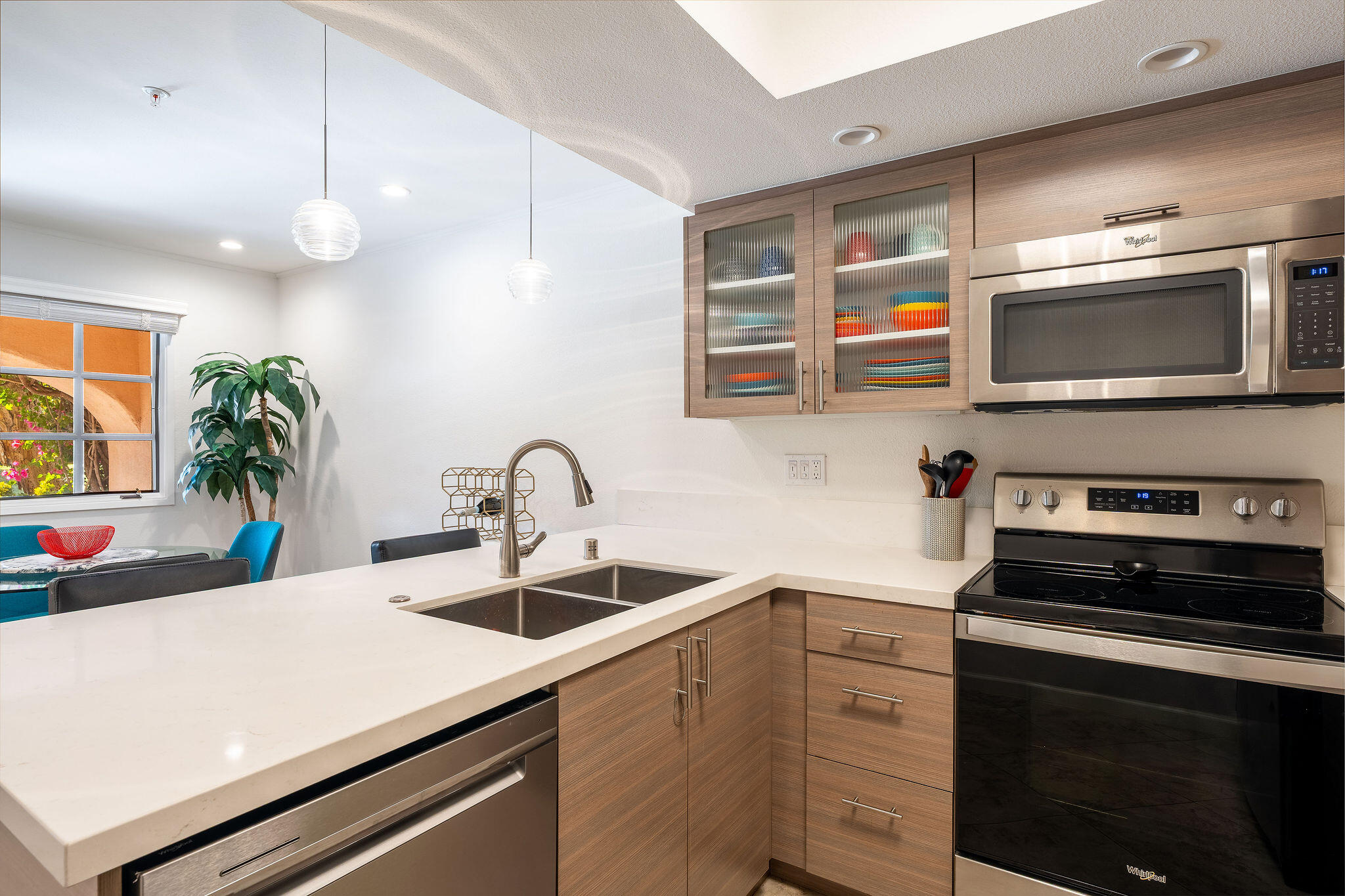 500 East Amado Road, Unit 106 Palm Springs, CA 92262 - Photo 7 of 30 a kitchen with stainless steel appliances a stove a sink and a microwave