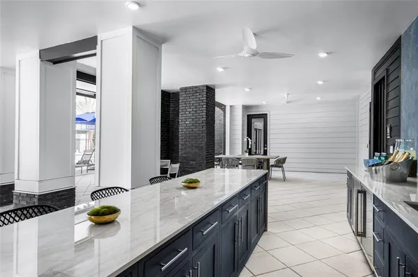 a bathroom with a granite countertop sink and a bathtub