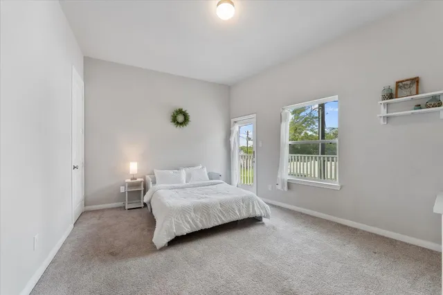 a bedroom with a bed lamp and window