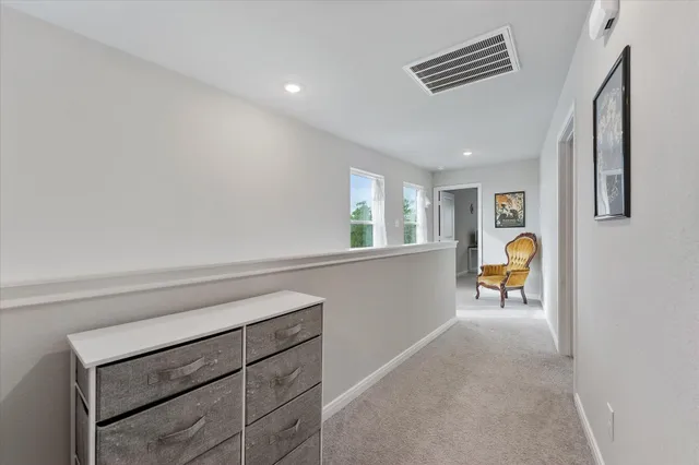 a hallway with a couch and chandelier