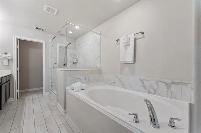 a bathroom with a bathtub and a shower