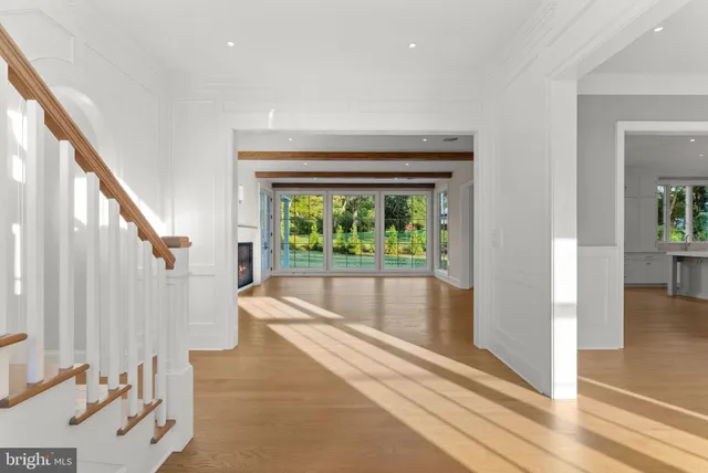 a view of empty room with wooden floor and fireplace