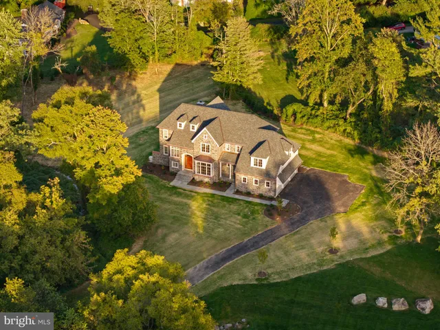 a front view of a house with a yard table and chairs