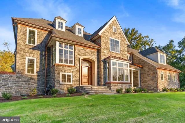 a front view of a brick house with a yard