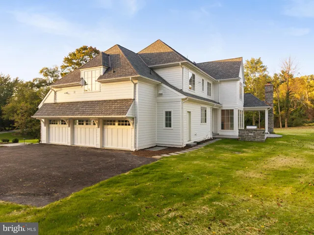 a view of an empty room with window and chandelier